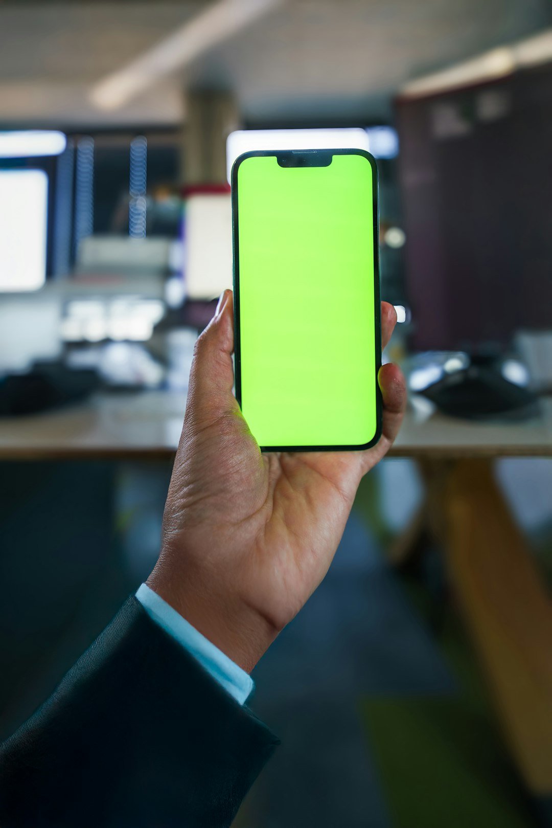 hand care smartphone empty green screen mockup office interior vertical business wear