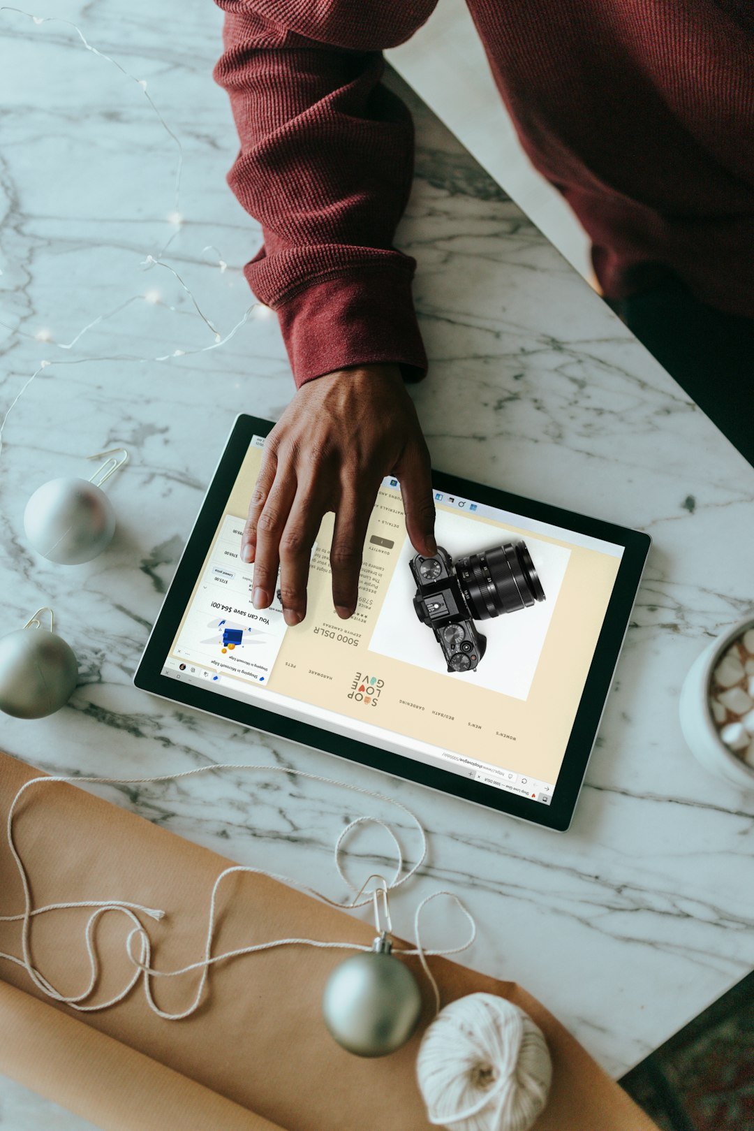 overhead-view-of-a-person-clicking-on-a-surface-laptop-with-wrapping-presents-around-nnwtohd-xmw