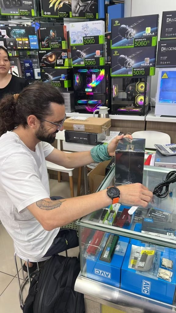 3C Nexus staff demonstrating smart devices in Huaqiangbei store