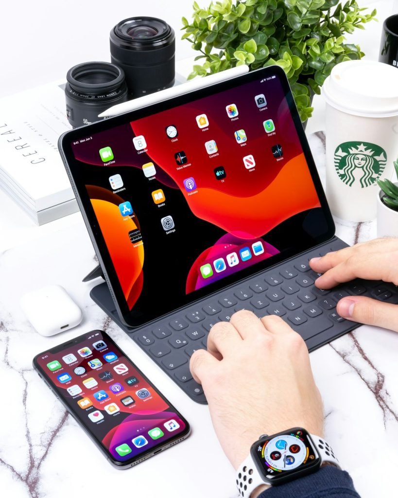 Person using tablet with Bluetooth keyboard for productivity